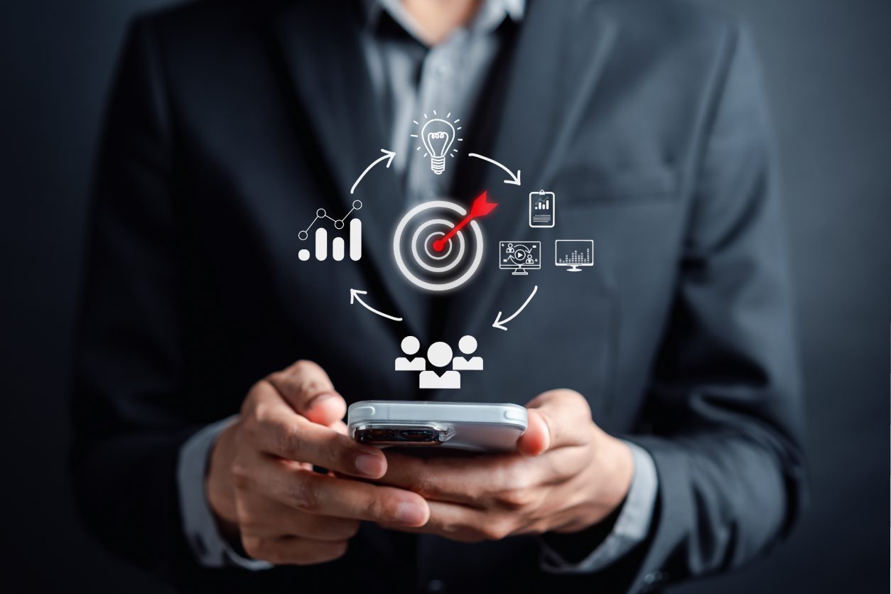 Businessman using smartphone with digital icons overlay.